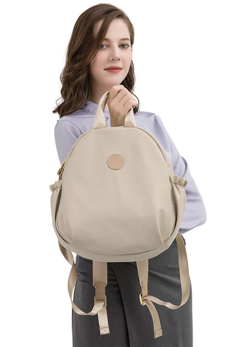 women cute small backpack purse in oval shape in water resistant soft fabric with top handle for travel or everyday use