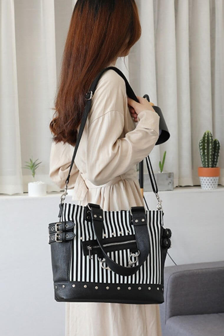 glow in the dark canvas tote bag | goth shopping tote for women | punk bag with ruckstuds | luminous bag in printed stripes | canvas tote bag with leather trim | crossbody tote bag with handcuff