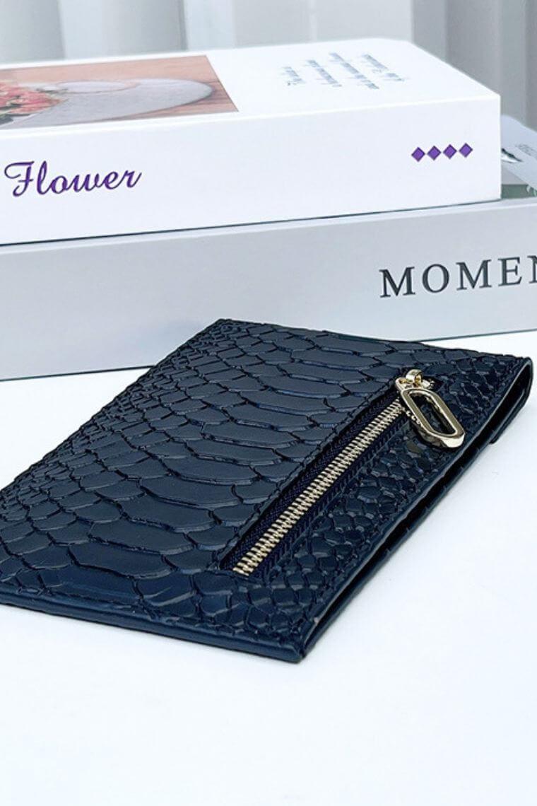 Snake embossed leather clutch bag with back zip pocket, 14 credit card slots