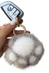 grey white paw print fur ball keyring